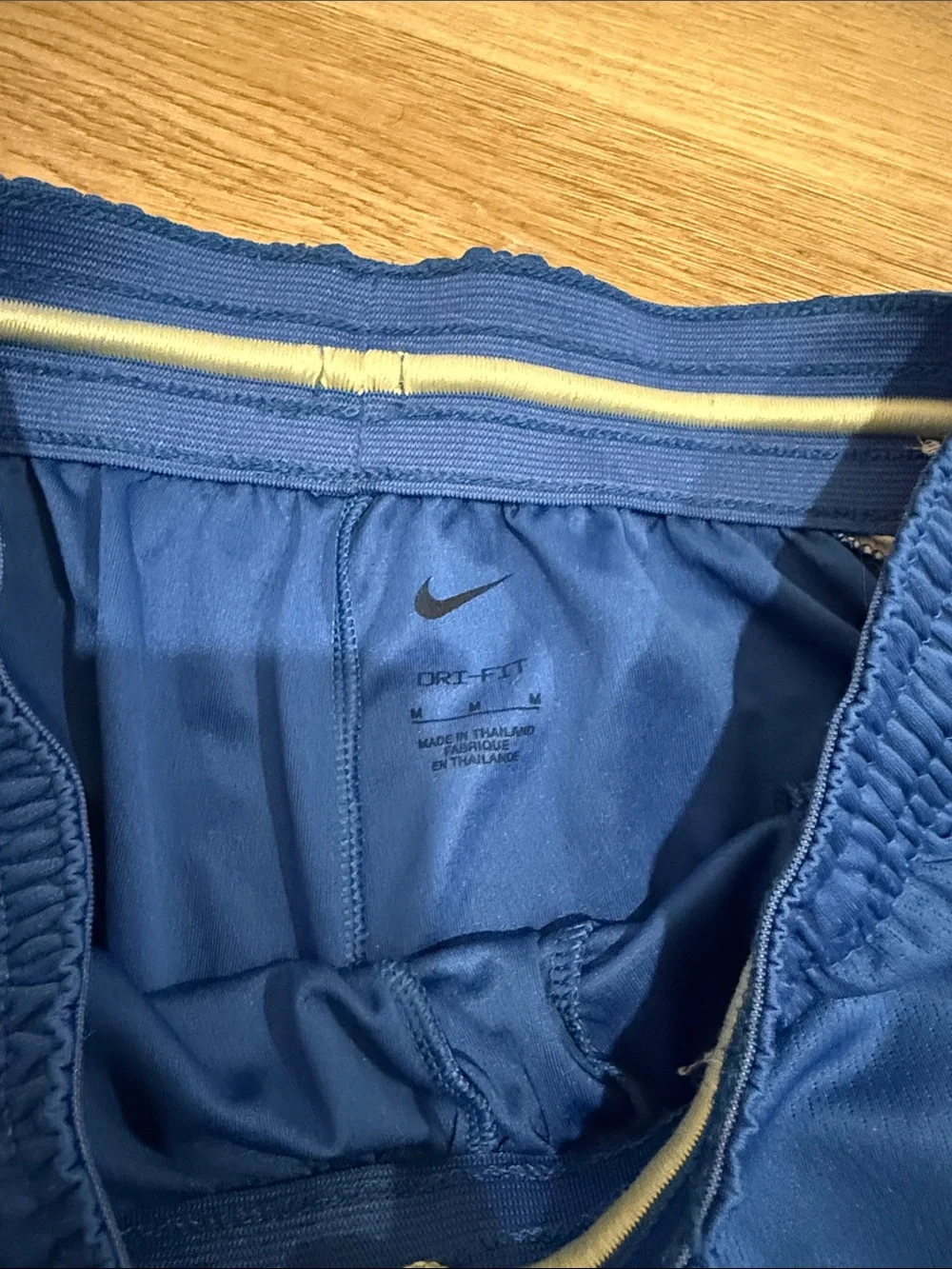 Nike Blue Athletic Shorts with Black Swoosh and Yellow Accent